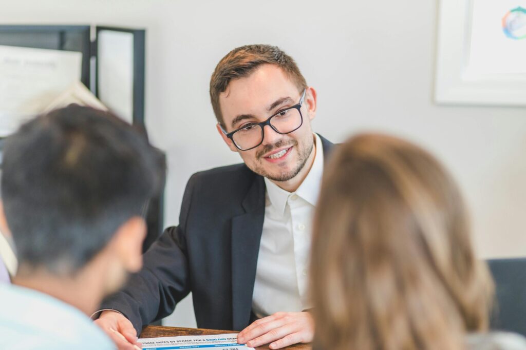 man in black suit jacket discussing to his clients